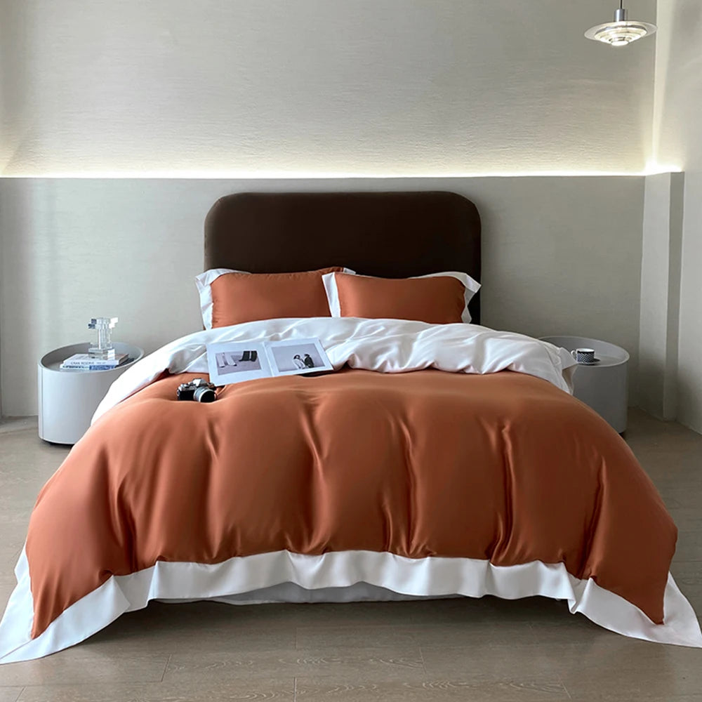 Lit fait avec parure de lit en soie pour sommeil réparateur ORANGE ET BLANC